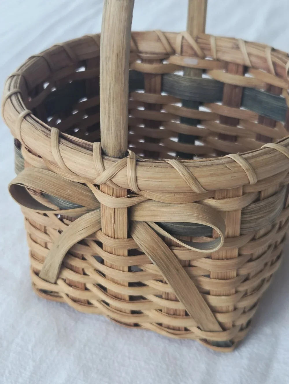 Vintage, Hand-Woven Basket Featuring A Unique Bow Detail And Green Accent